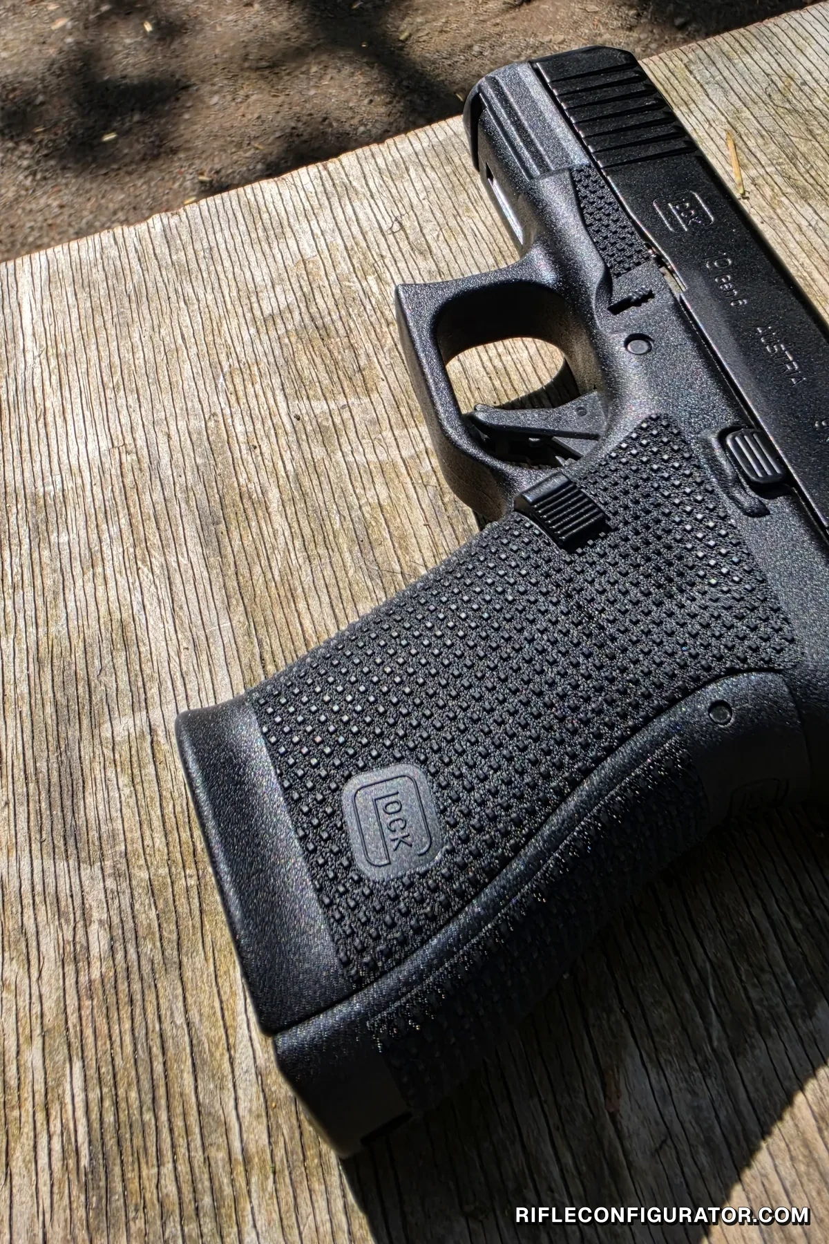 Close-up of a Glock 19 Gen6 lying on a wooden bench, showing the RTF6 dual-pattern grip texture, the undercut trigger guard, and the 19 Gen6 slide rollmark
